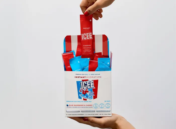 Hand pulling an ICEE stick pack from the box